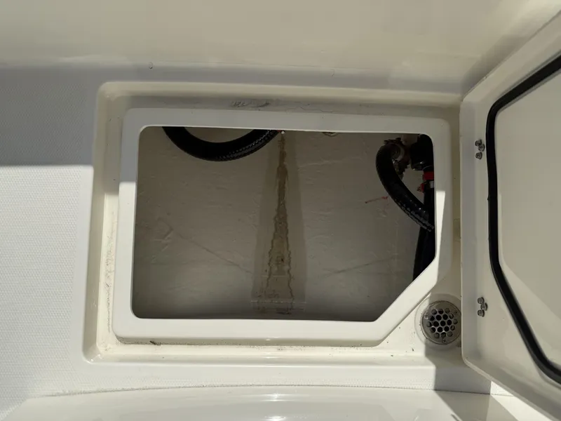 Slide: The Image of Open storage compartment on 2025 Pathfinder 2400 Open boat, showing interior and drainage. - 19
