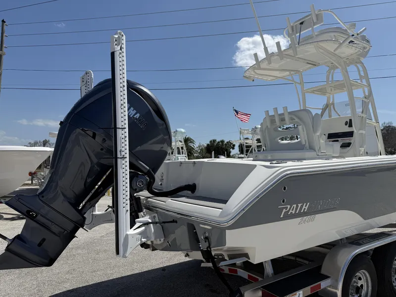 Slide: The Image of 2025 Pathfinder 2400 Open boat with Yamaha outboard motor, parked on a trailer. - 2