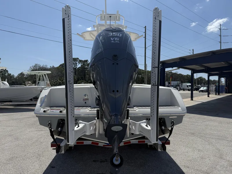 Slide: The Image of 2025 Pathfinder 2400 Open boat with powerful 350 V6 engine, parked outdoors. - 25