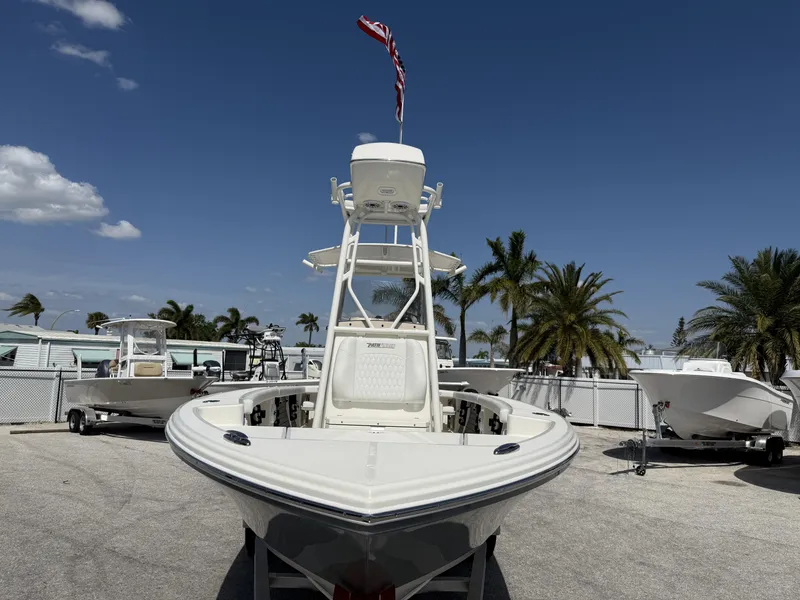 Slide: The Image of 2025 Pathfinder 2400 Open boat displayed outdoors with palm trees and clear sky. - 29