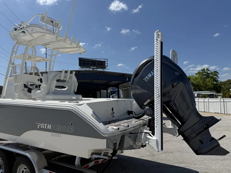 Slide: The Image of 2025 Pathfinder 2400 Open boat with Yamaha outboard motor on trailer under clear sky. - 3