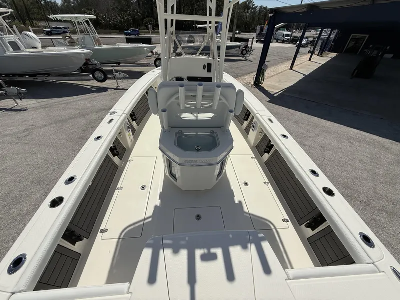 Slide: The Image of 2025 Pathfinder 2400 Open boat interior, featuring spacious deck and seating, parked at a marina. - 32