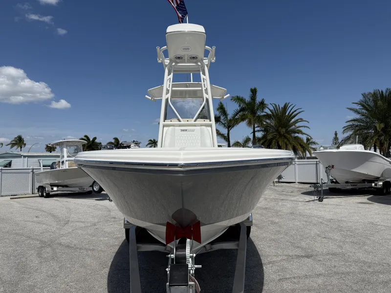 Slide: The Image of 2025 Pathfinder 2400 Open boat on trailer, sunny day, palm trees in background. - 5