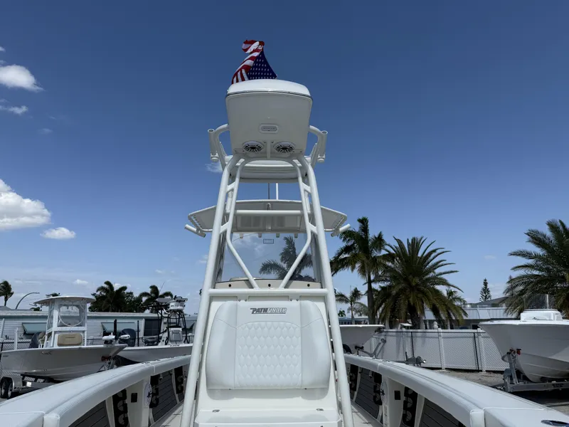 Slide: The Image of 2025 Pathfinder 2400 Open boat with American flag, clear sky, and palm trees in the background. - 6