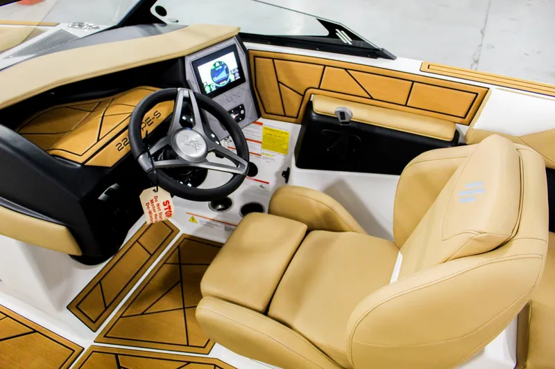 Slide: The Image of 2025 ATX Surf Boats 22 Type-S interior with tan seating and modern dashboard. - 10