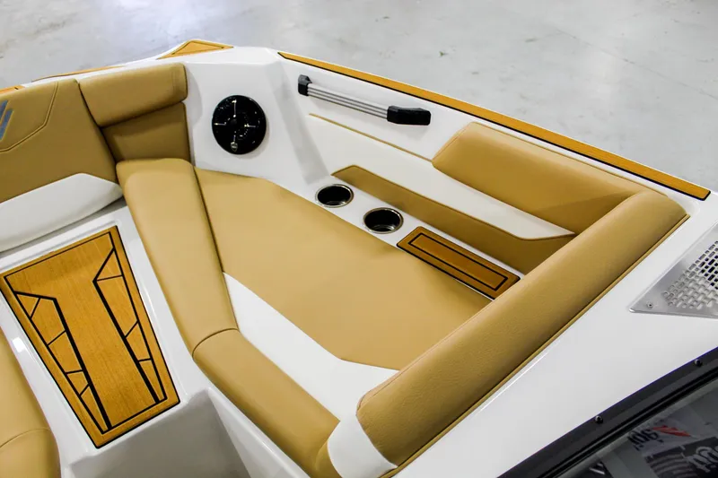 Slide: The Image of 2025 ATX Surf Boats 22 Type-S interior with tan seating and cup holders. - 12