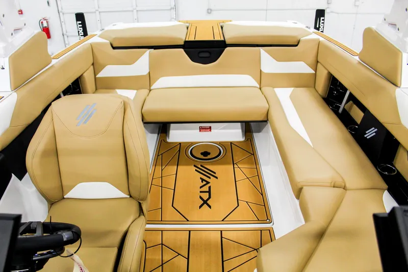 Slide: The Image of 2025 ATX Surf Boats 22 Type-S interior with tan and white seating. - 13