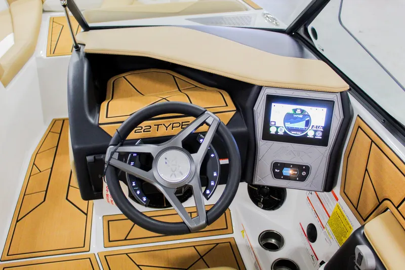 Slide: The Image of 2025 ATX Surf Boats 22 Type-S dashboard with steering wheel and digital display. - 14