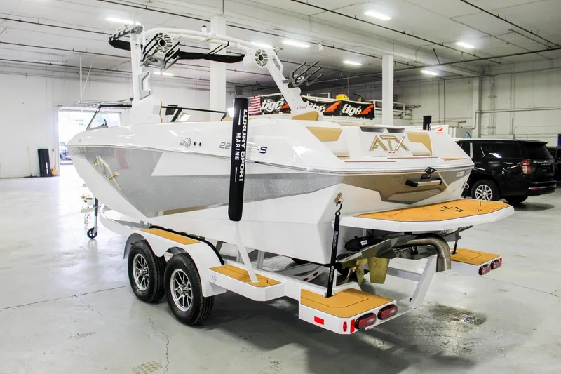 Slide: The Image of 2025 ATX Surf Boats 22 Type-S on trailer in indoor showroom. - 2