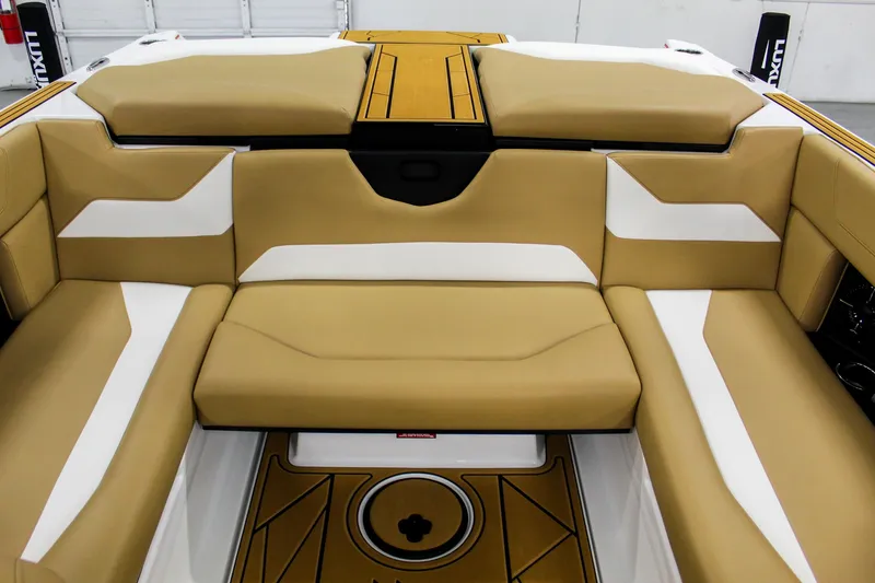 Slide: The Image of 2025 ATX Surf Boats 22 Type-S interior with tan and white seating. - 20