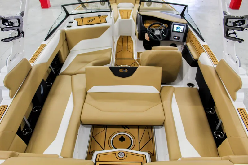 Slide: The Image of 2025 ATX Surf Boats 22 Type-S interior with tan and white seating, modern dashboard, and spacious layout. - 22