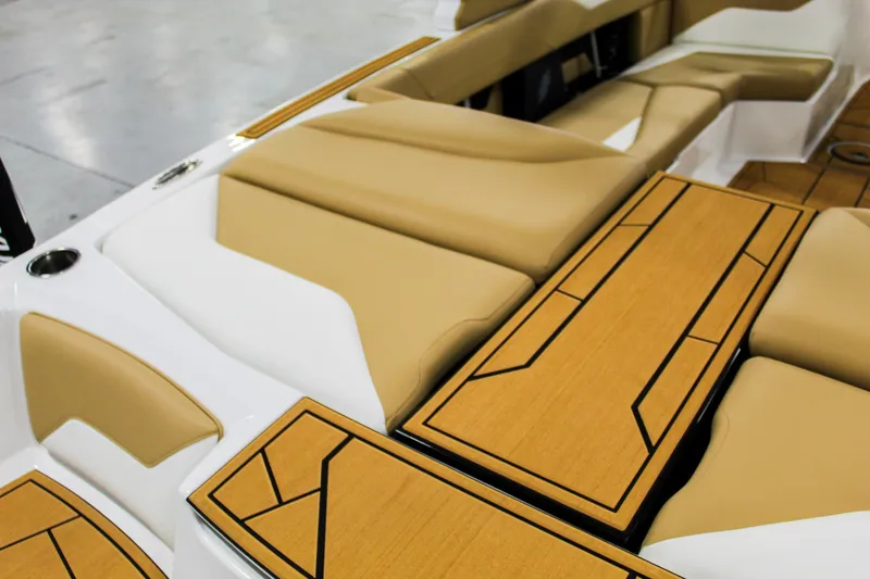 Slide: The Image of 2025 ATX Surf Boats 22 Type-S interior with tan seating and stylish wood accents. - 23