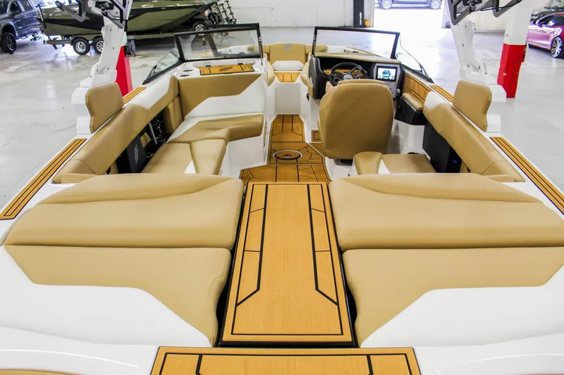 Slide: The Image of 2025 ATX Surf Boats 22 Type-S interior with tan seating and modern dashboard. - 24