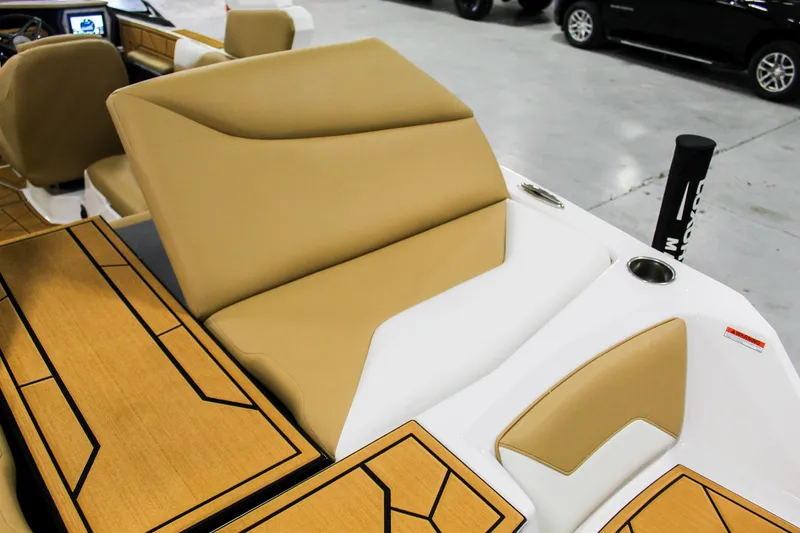 Slide: The Image of 2025 ATX Surf Boats 22 Type-S interior with tan and white seating, cup holders, and sleek design. - 26