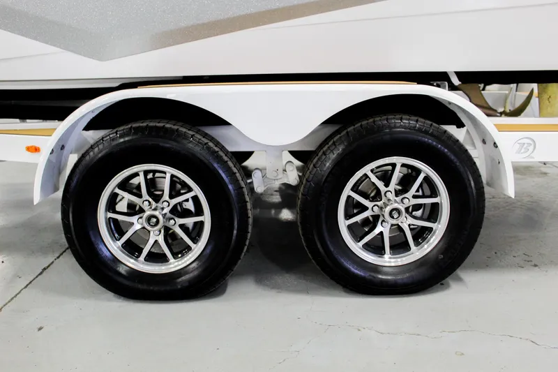 Slide: The Image of 2025 ATX Surf Boats 22 Type-S trailer wheels, featuring dual axles and sleek alloy rims. - 31