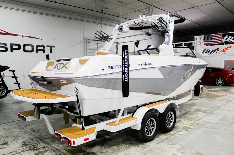 Slide: The Image of 2025 ATX Surf Boats 22 Type-S on trailer in showroom, featuring sleek design and modern features. - 5
