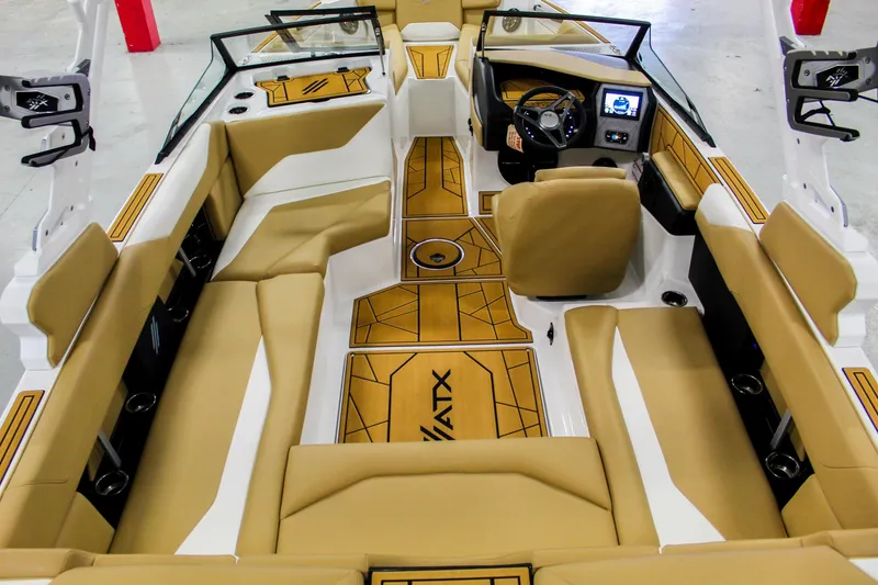 Slide: The Image of 2025 ATX Surf Boats 22 Type-S interior with tan seating and modern dashboard. - 8