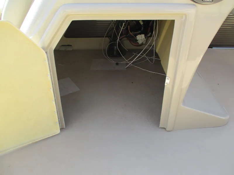 Slide: The Image of 2019 Crest FISH 200 C4 boat storage compartment with visible wiring. - 11