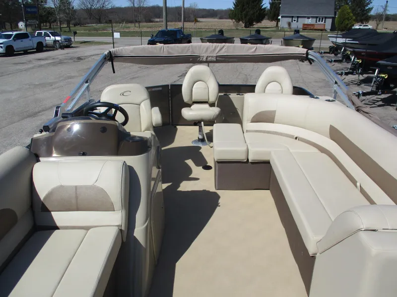 Slide: The Image of 2019 Crest FISH 200 C4 pontoon boat with spacious seating and helm, parked outdoors. - 21