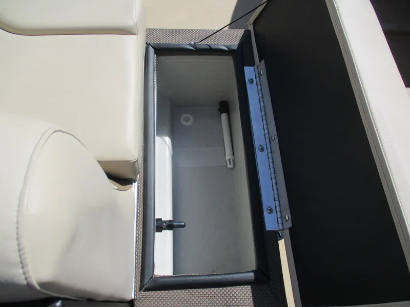 Slide: The Image of Open storage compartment on 2019 Crest FISH 200 C4 boat, featuring beige seating. - 5