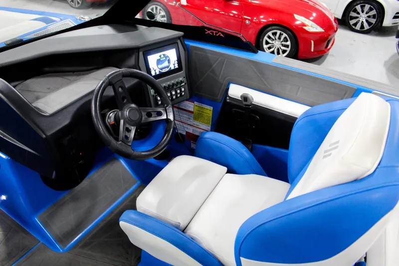 Slide: The Image of 2020 ATX Surf Boats 24 Type-S cockpit with blue and white seating, modern dashboard. - 10