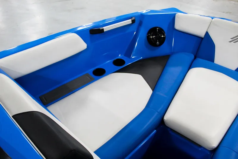 Slide: The Image of 2020 ATX Surf Boats 24 Type-S interior with blue and white seating and cup holders. - 11