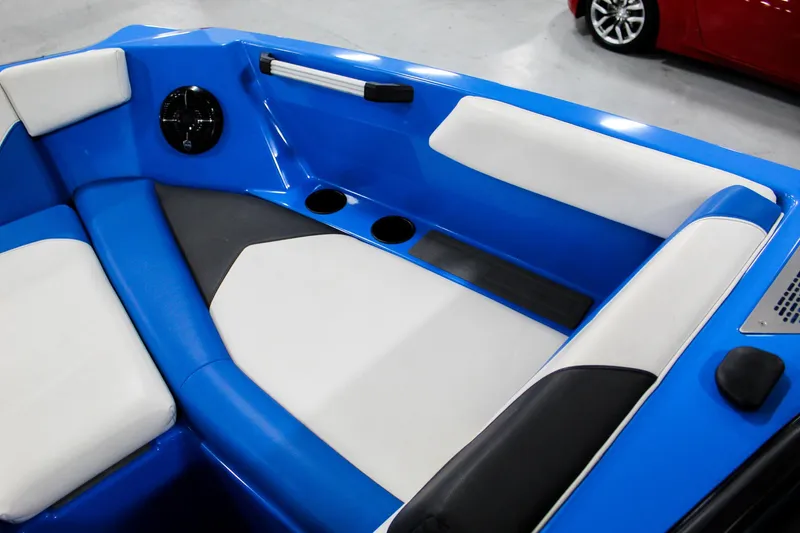 Slide: The Image of 2020 ATX Surf Boats 24 Type-S interior with blue and white seating, cup holders. - 12