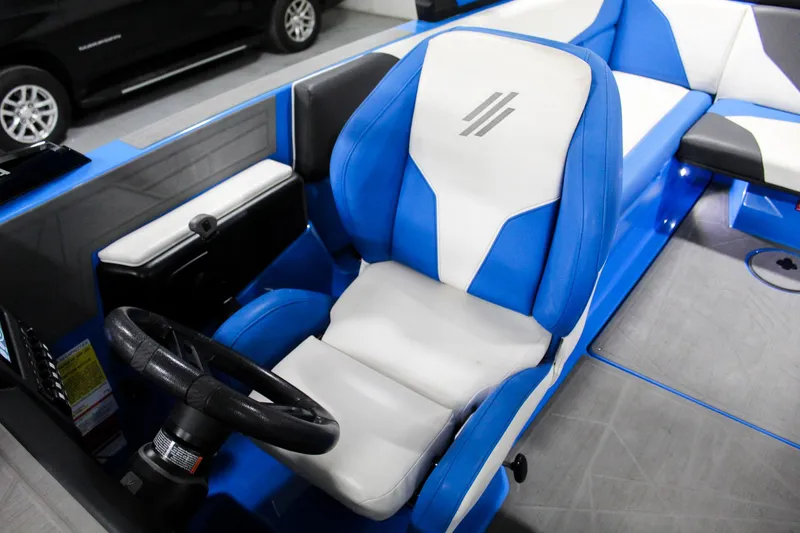 Slide: The Image of 2020 ATX Surf Boats 24 Type-S interior with blue and white captain's seat and steering wheel. - 18