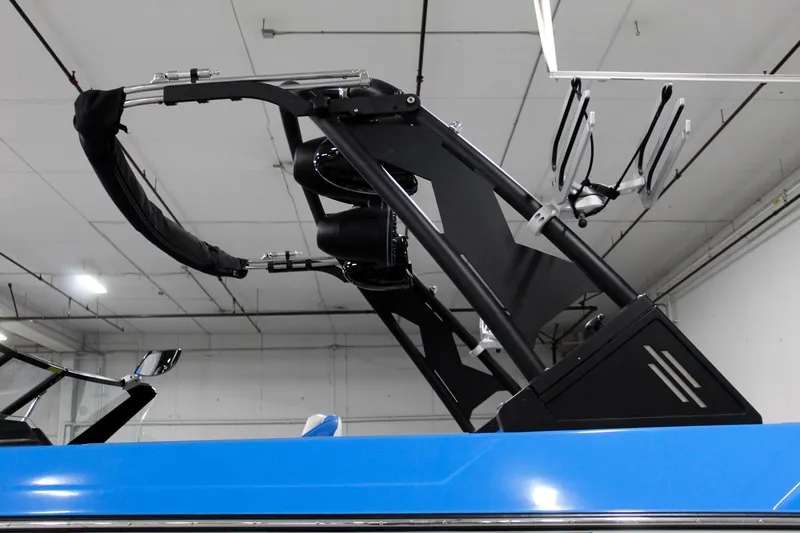 Slide: The Image of 2020 ATX Surf Boats 24 Type-S with sleek black wakeboard tower in a showroom. - 25