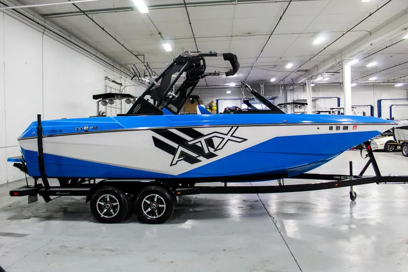 Slide: The Image of 2020 ATX Surf Boats 24 Type-S, blue and white, in a showroom on a trailer. - 7