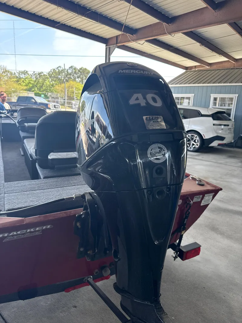 Slide: The Image of 2025 Tracker Panfish 17 boat with Mercury 40 outboard motor in a covered area. - 3