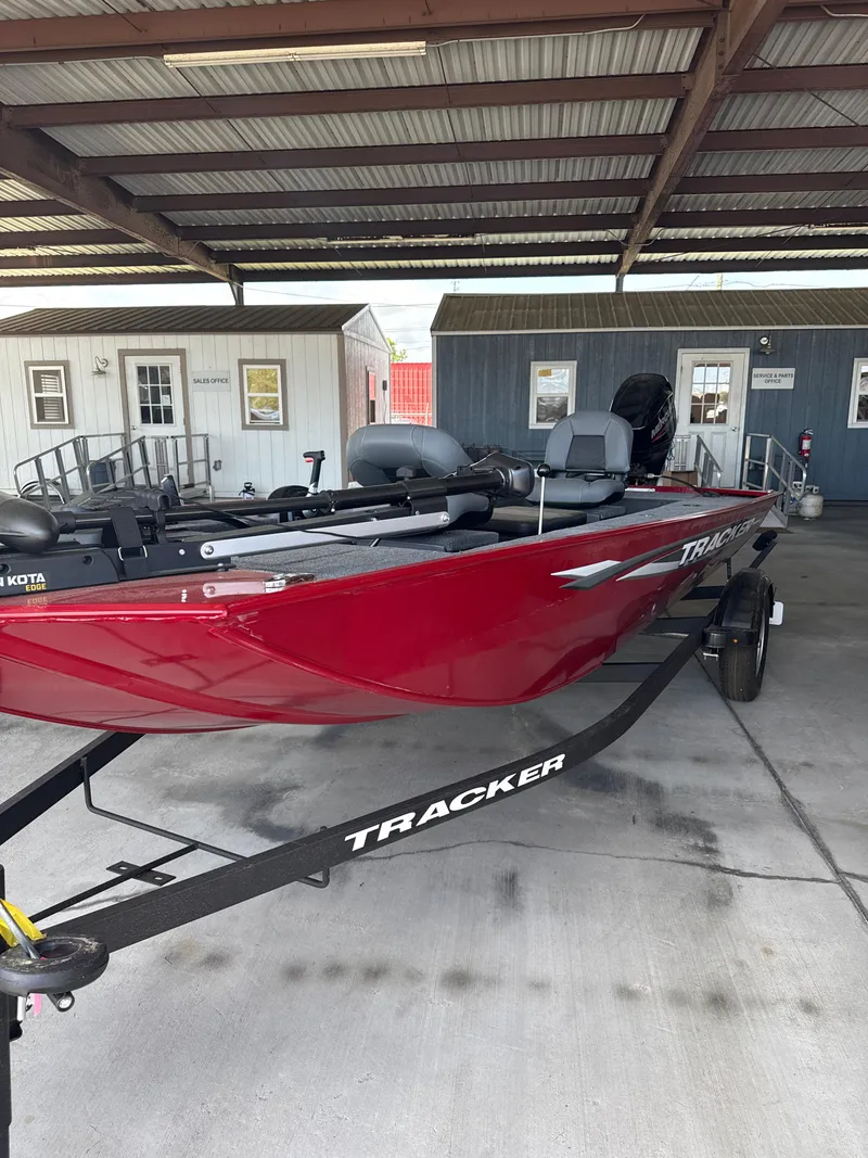 Slide: The Image of 2025 Tracker Panfish 17 boat in red, parked under a metal canopy. - 5