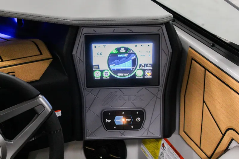 Slide: The Image of 2025 ATX Surf Boats 24 Type-S dashboard with touchscreen display and controls. - 16