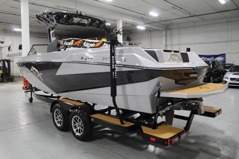 Slide: The Image of 2025 ATX Surf Boats 24 Type-S in showroom, on trailer, rear view. - 2