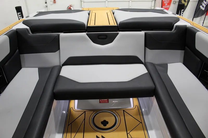 Slide: The Image of 2025 ATX Surf Boats 24 Type-S interior with sleek black and gray seating design. - 20