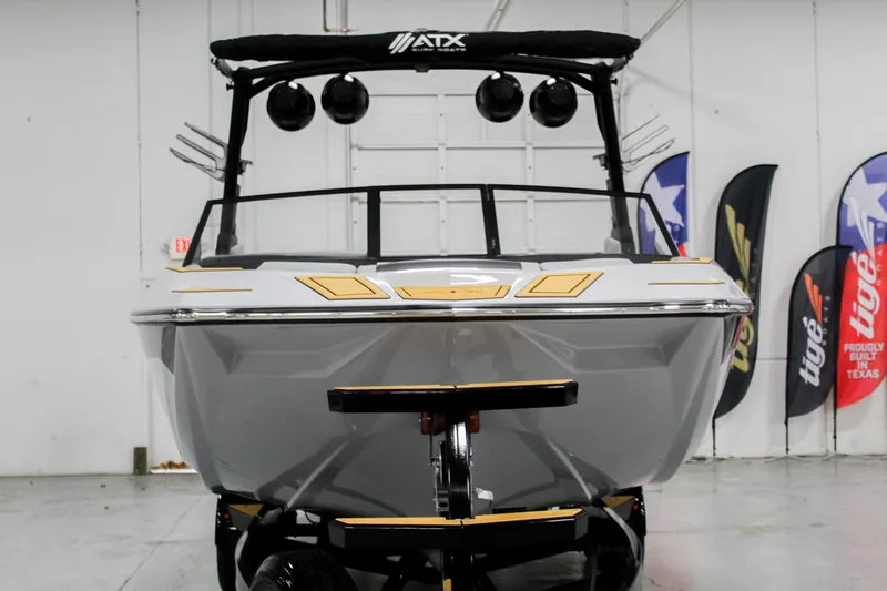 Slide: The Image of 2025 ATX Surf Boats 24 Type-S in showroom, front view with sleek design and speakers. - 3