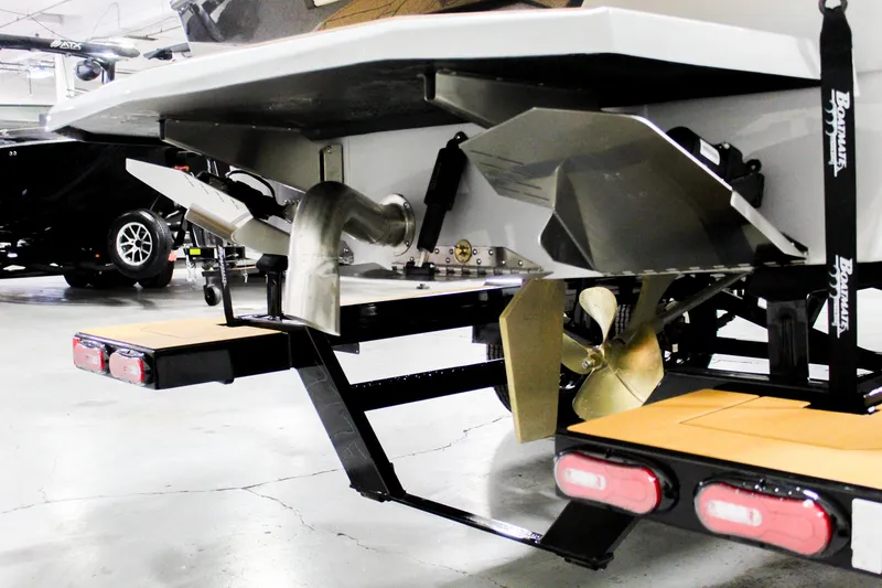 Slide: The Image of 2025 ATX Surf Boats 24 Type-S rear view, showcasing propeller and exhaust system. - 33