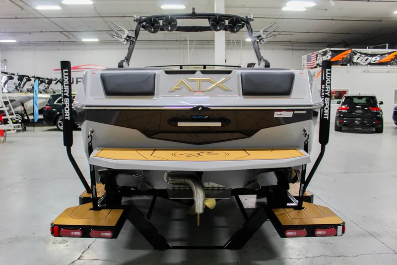 Slide: The Image of 2025 ATX Surf Boats 24 Type-S in showroom, rear view with swim platform. - 4