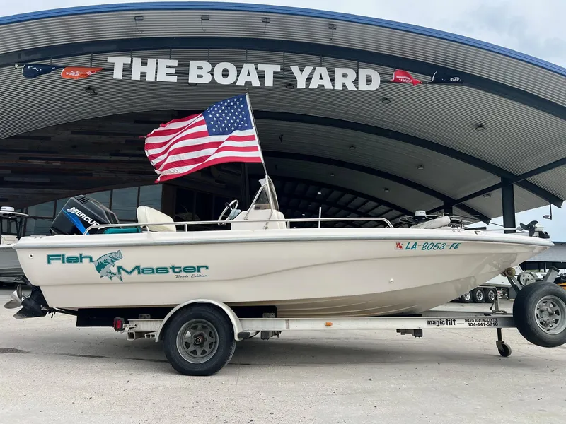 Slide: The Image of Fishmaster 1960 boat, 2002 model, with American flag at The Boat Yard. - 1