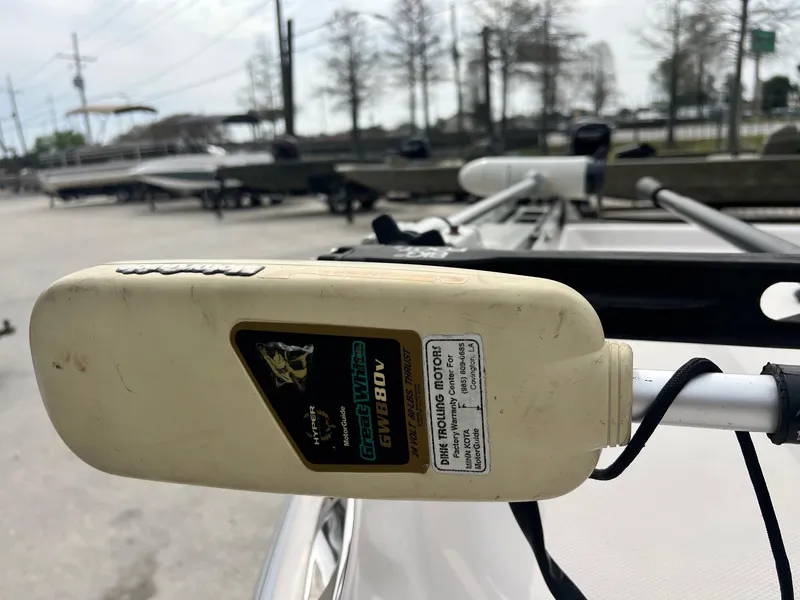 Slide: The Image of Close-up of a Fishmaster 1960 trolling motor, model year 2002, in a boatyard setting. - 12
