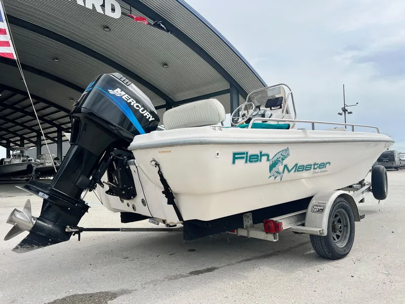 Slide: The Image of Fishmaster 1960 boat, 2002 model, with Mercury engine on trailer at marina. - 3