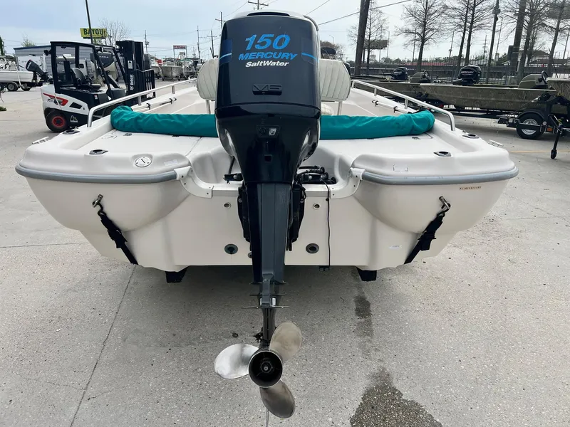 Slide: The Image of Fishmaster 1960 boat, 2002 model, with Mercury 150 Saltwater engine, parked outdoors. - 4