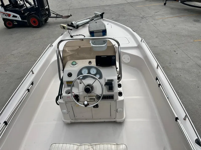 Slide: The Image of Center console of a 2002 Fishmaster 1960 boat, featuring steering wheel and gauges. - 7