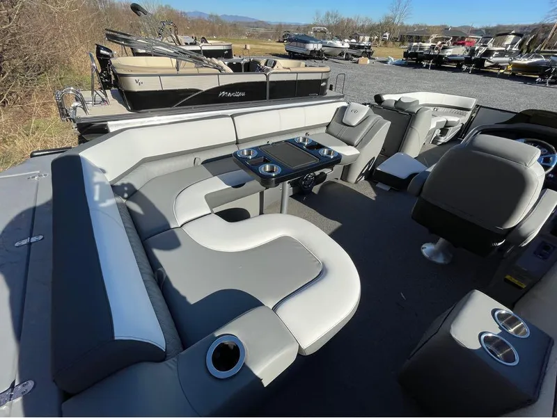 Slide: The Image of 2021 Avalon Catalina Rear J Lounger 25' interior with plush seating and cup holders. - 27