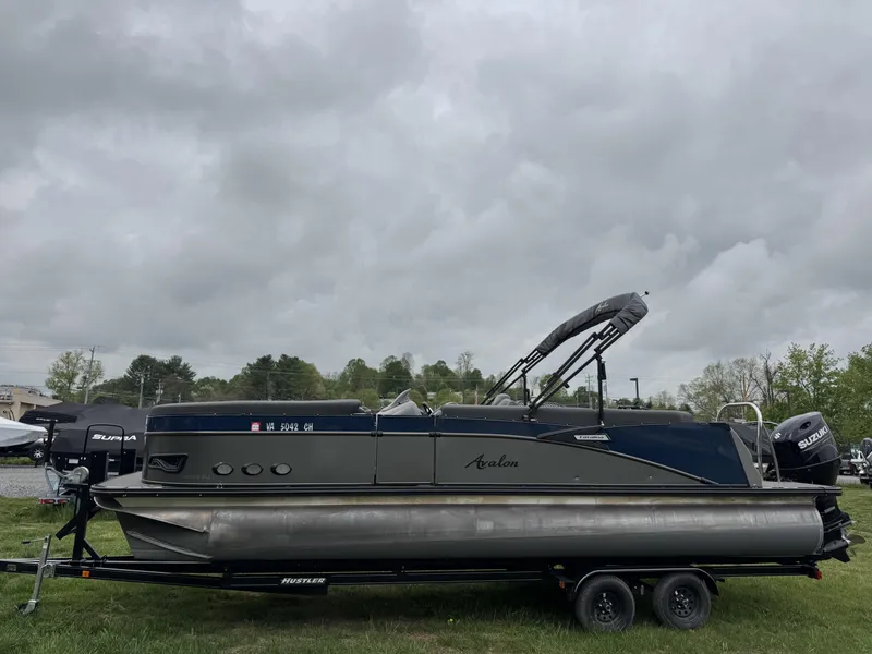Slide: The Image of 2021 Avalon Catalina Rear J Lounger 25' pontoon boat on trailer, overcast sky. - 32
