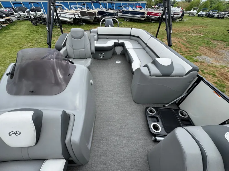 Slide: The Image of 2021 Avalon Catalina Rear J Lounger 25' pontoon boat interior with gray seating and helm. - 36