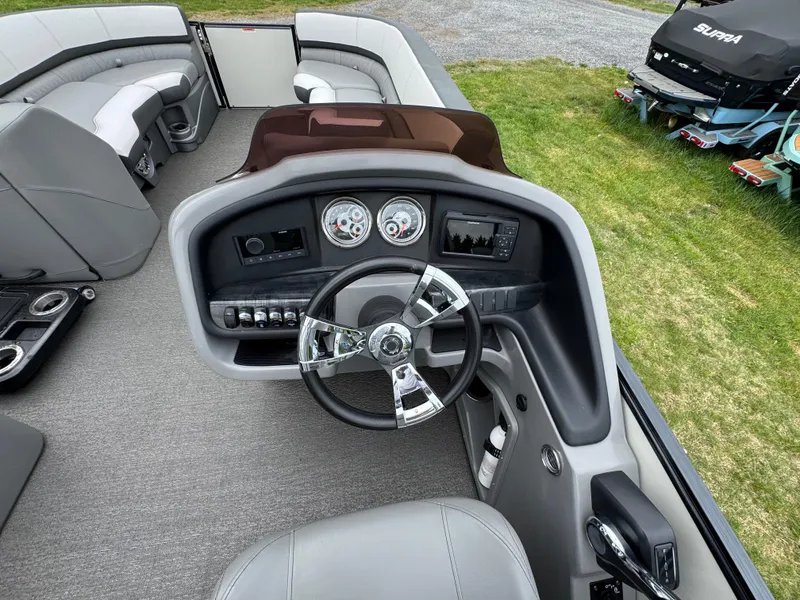 Slide: The Image of 2021 Avalon Catalina Rear J Lounger 25' boat interior with steering console and seating. - 39