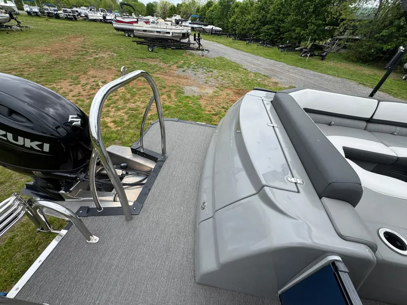 Slide: The Image of 2021 Avalon Catalina Rear J Lounger 25' boat with Suzuki motor, parked on grass. - 42