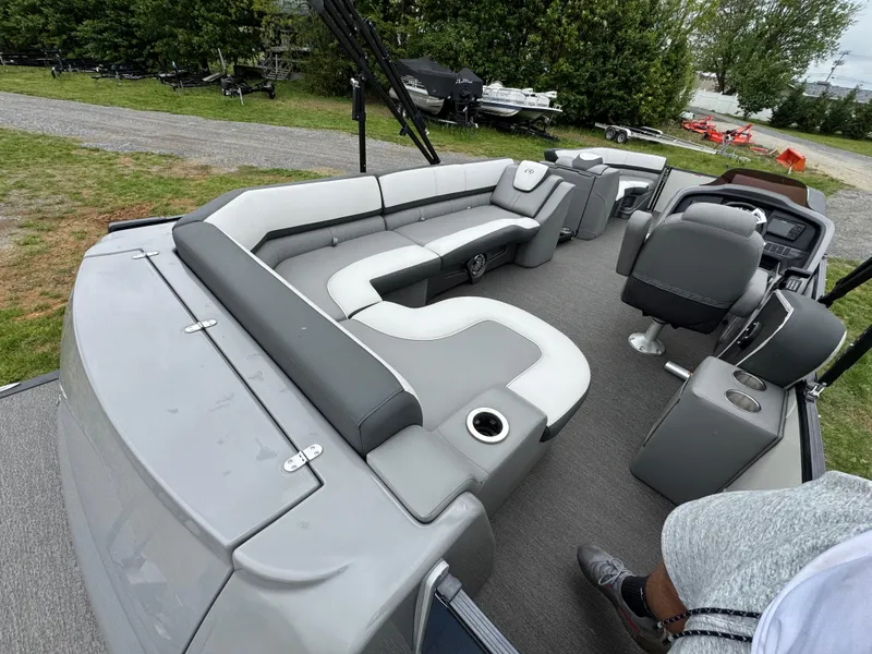 Slide: The Image of 2021 Avalon Catalina Rear J Lounger 25' pontoon boat interior with gray seating and helm. - 43