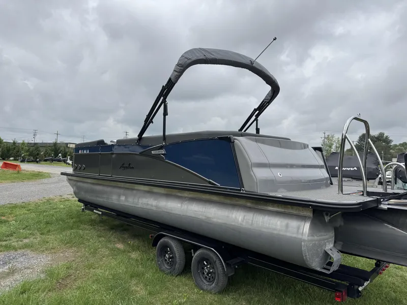 Slide: The Image of 2021 Avalon Catalina Rear J Lounger 25' pontoon boat on trailer, overcast sky. - 7